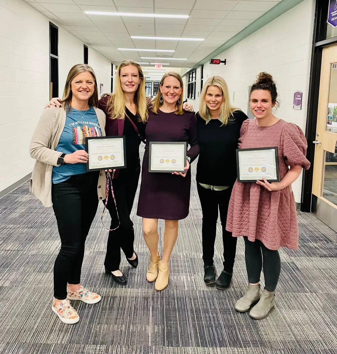 Five women holding SWEL certification certificates in a school hallway in Wyoming, Michigan